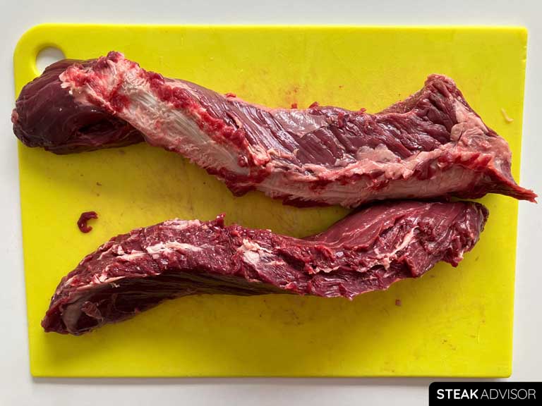 A raw hanger steak, split into two pieces