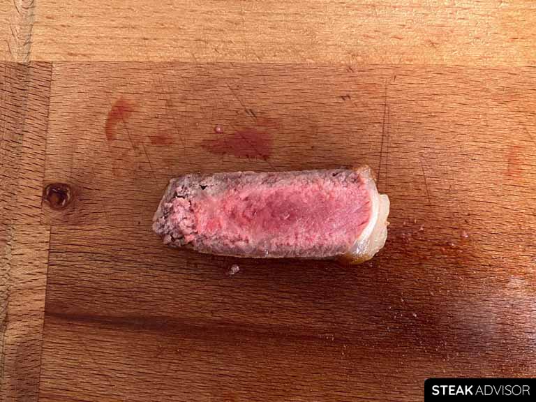 A slice of strip steak, salted 45 minutes before cooking and cooked to a medium-rare