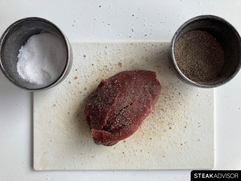 Steak seasoned with kosher salt and finely ground black pepper.