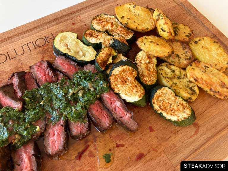 Chimichurri steak served with baked zucchini and potatoes
