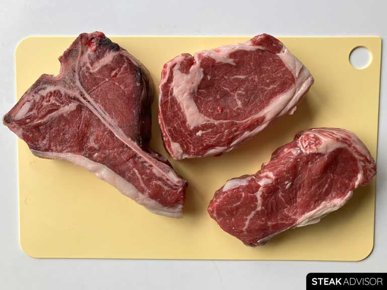 Porterhouse steak, ribeye steak and strip steak also known as new york strip
