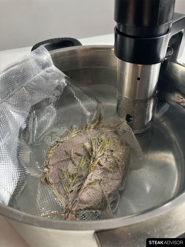 Steak cooking in a sous vide water bath inside a sealed bag