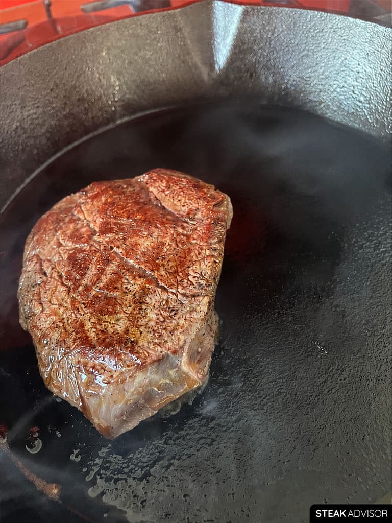 Sous vide steak being seared in a hot pan for the final crust