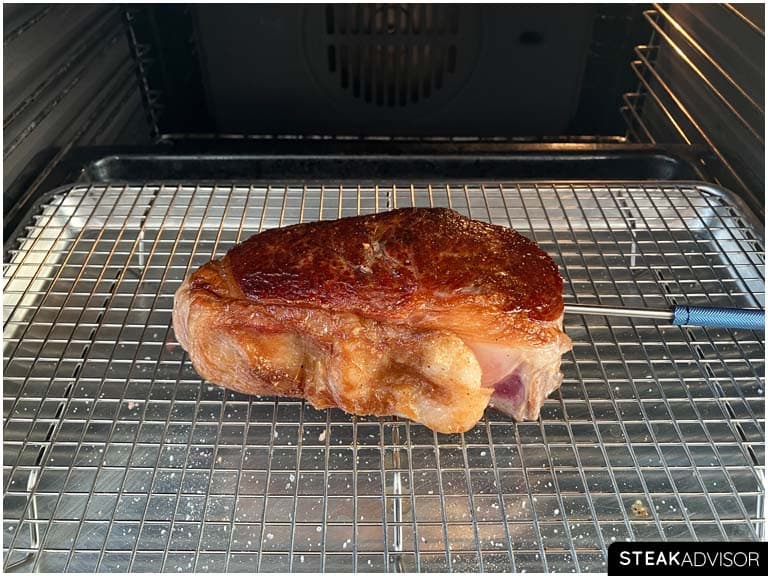 A steak placed in the oven to finish cooking
