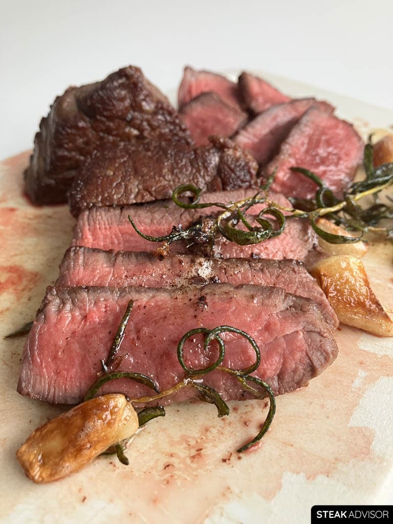 Pan-seared filet mignon sliced and served with aromatics