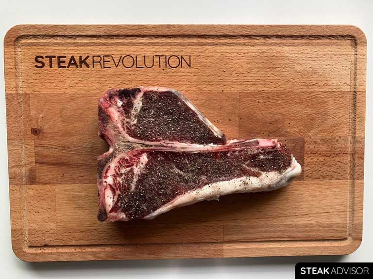 Porterhouse steak seasoned with ground black pepper