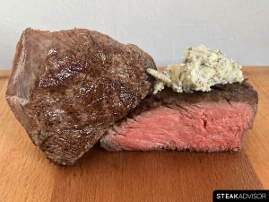 Sous vide steak served with classic aromatics such as garlic, herbs, and compound butter.