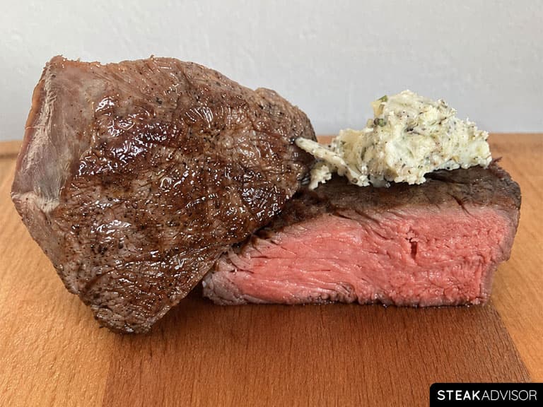 Sous vide steak served with classic aromatics such as garlic, herbs, and compound butter.