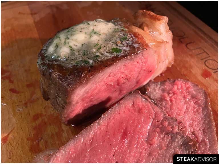 Sliced steak with compound butter on top