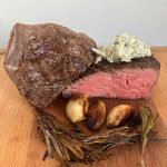 Sous vide steak served with classic aromatics such as garlic, herbs, and compound butter.