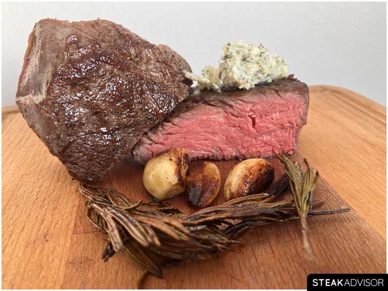 Sous vide steak served with garlic herbs and butter horizontal view