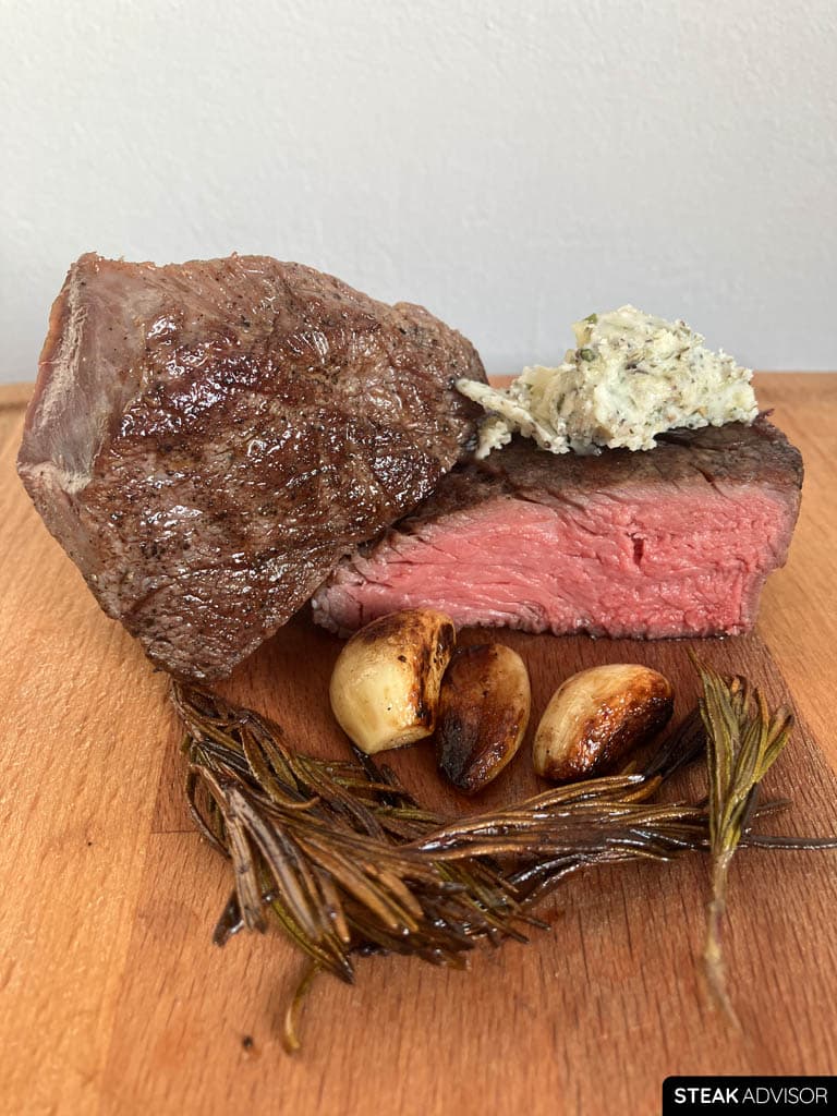 Sous vide steak served with classic aromatics such as garlic, herbs, and compound butter.