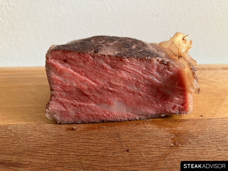 Steak cooked to medium-rare doneness at 135°F or 57°C