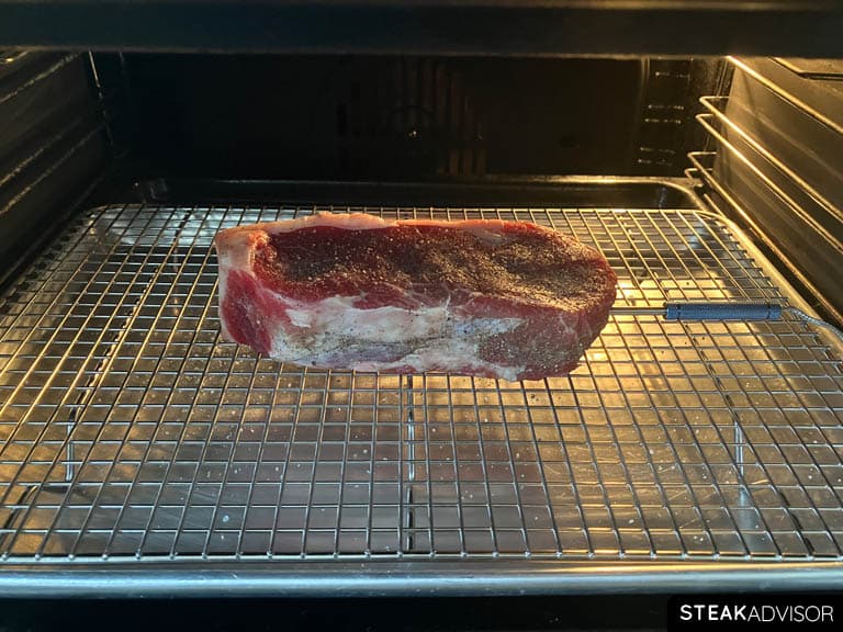 Steak cooking in the oven with a temperature probe inserted in the center