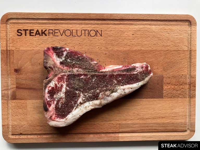 T-bone steak seasoned with ground black pepper