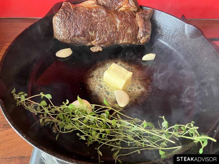 Thyme garlic cloves and butter in a pan