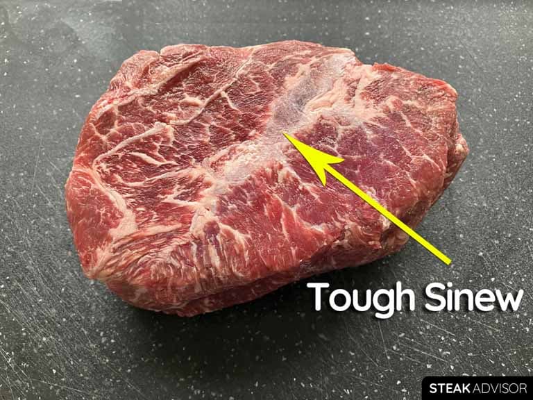 Tough sinew in the top blade steak