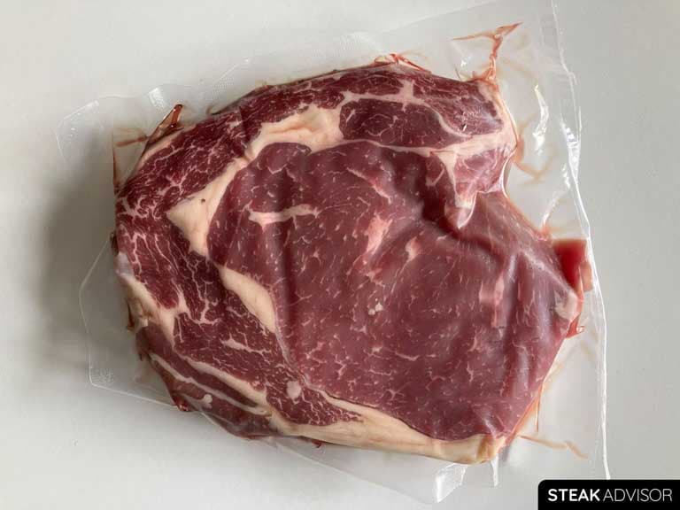 Vacuum-packed raw ribeye steak