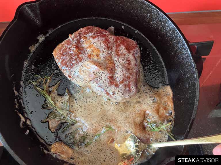 Baste the top blade steak with the melted butter