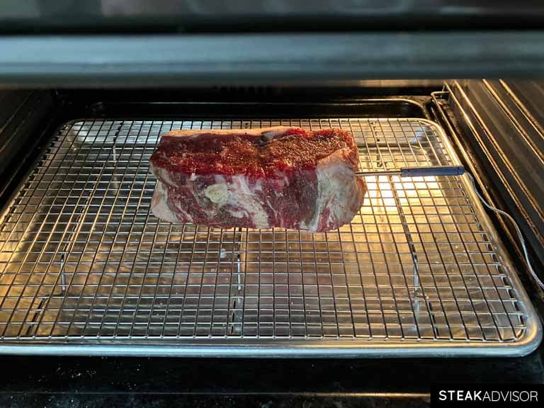 Dry-aged steak on a wire rack in the oven.