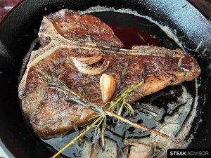 Pan-seared t-bone steak; medium-rare doneness