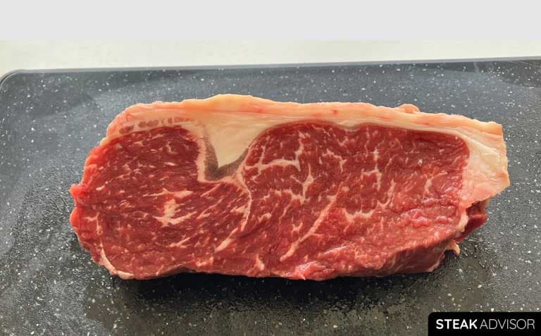 raw strip steak marbling