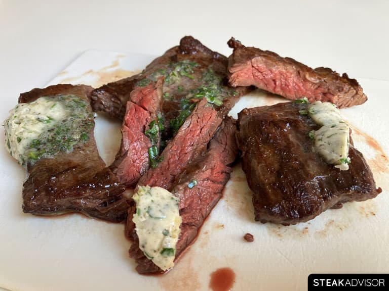 sliced pan seared outside skirt steak served with compound butter
