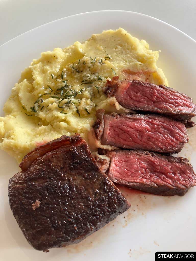 Sliced steak and garlic herb mashed potatoes