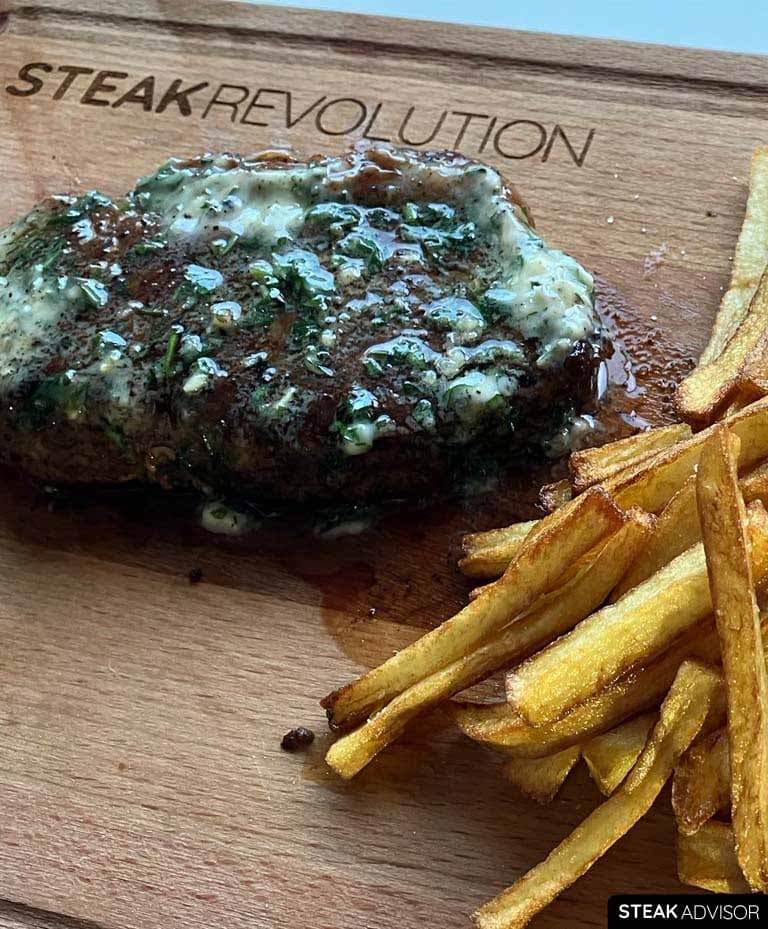 steak and frites served with garlic herbs compound butter