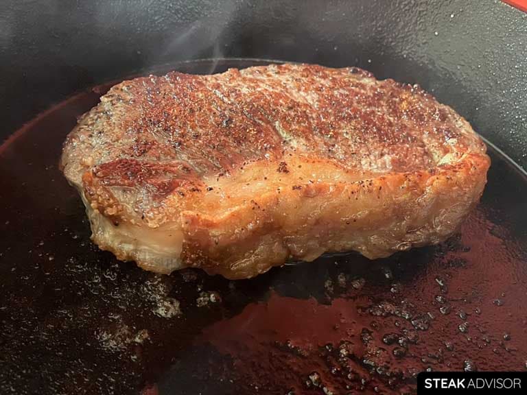Strip steak cooked in a cast iron skillet