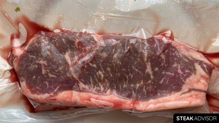 Thawed new york strip steak in the refrigerator